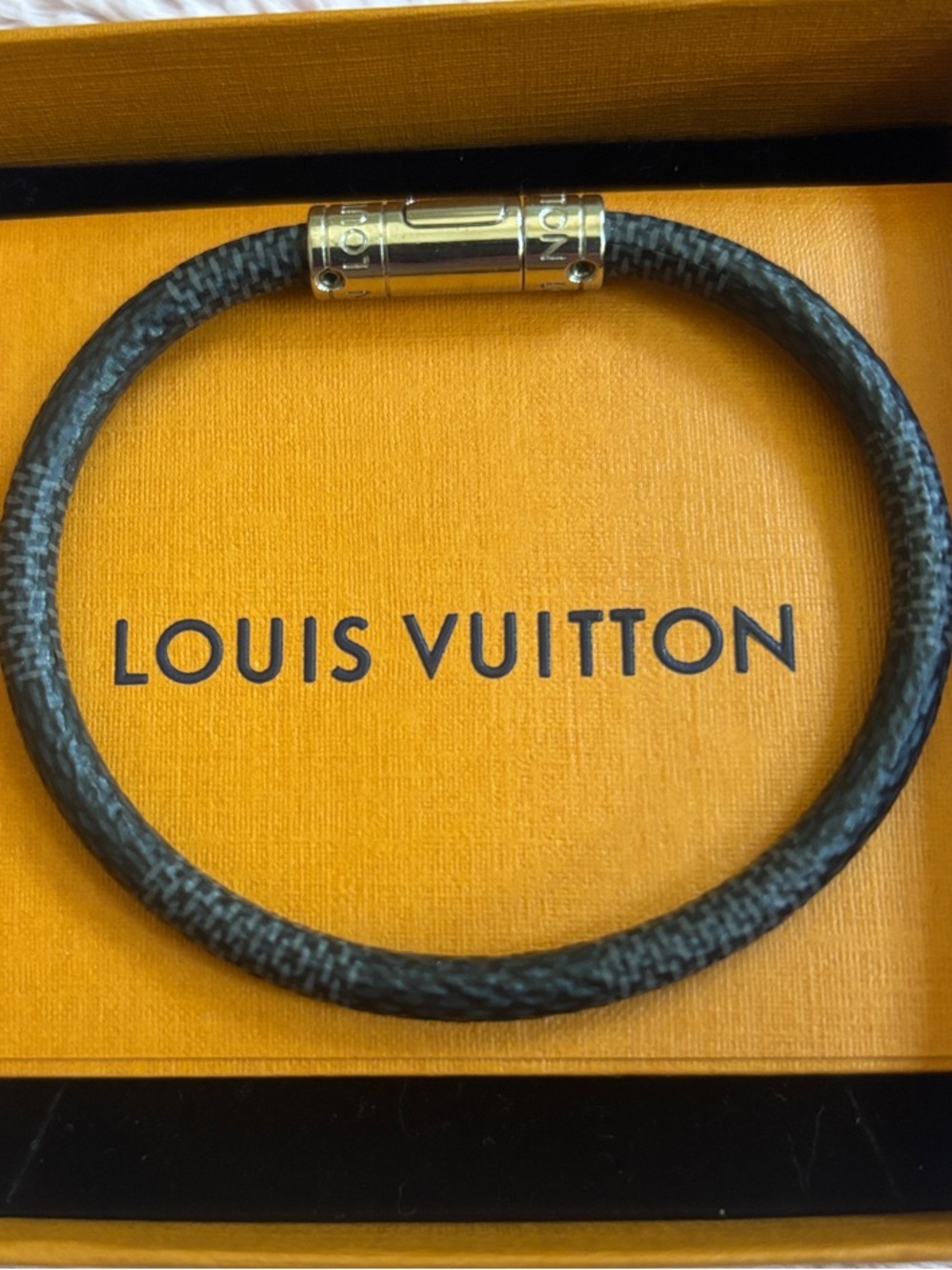 Louis Vuitton Black Braided Bracelet with Silvertone clasp.
